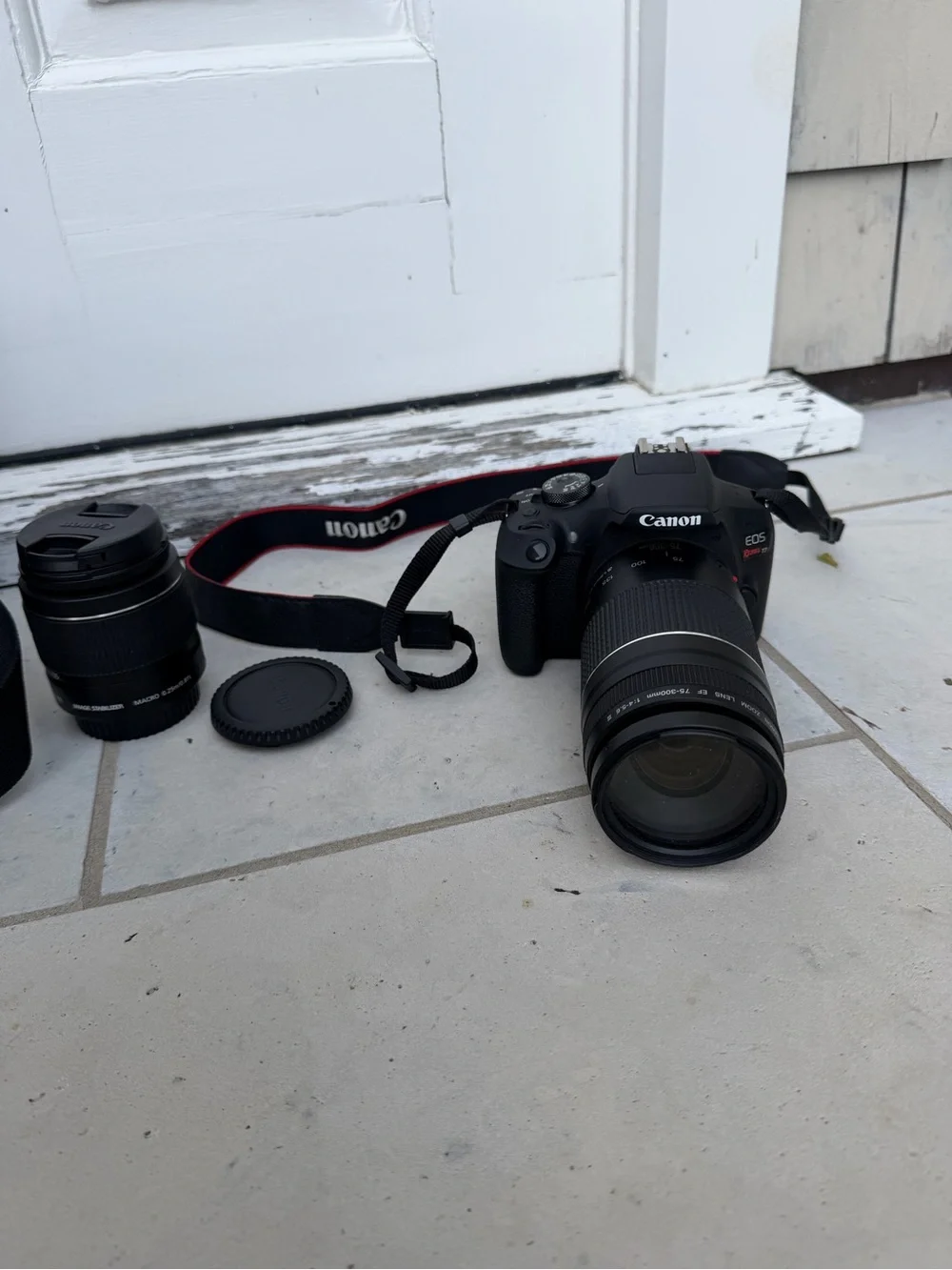 Canon DSLR Camera in Black with Red-Trim Strap and Black Zoom Lens